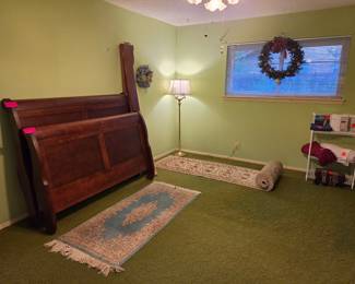 Cherrywood furniture, oriental rugs, and blankets