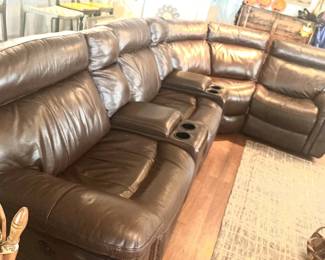 Brown leather sectional w/reclining end seats. Looks like a good napping place to me.