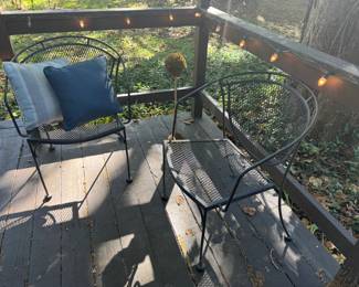 two wrought iron black patio chairs