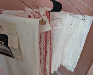 Many more tablecloths than these, labeled with sizes.
