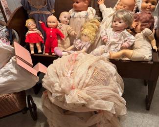 Under these cutie dolls you'll find an antique storage bench