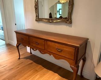 Queen Anne-style cherry wood console table featuring graceful cabriole legs and antiqued brass hardware