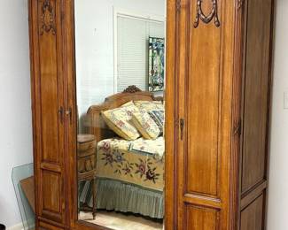 Antique Louis XVI style walnut armoire with three doors.