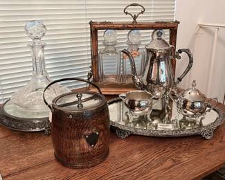Very nice collection of antique English decanter sets, Waterford crystal, silver-plate hollowware and mirrored plateaus.
