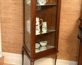 Antique oak corner cabinet with three mirror-plate shelves.