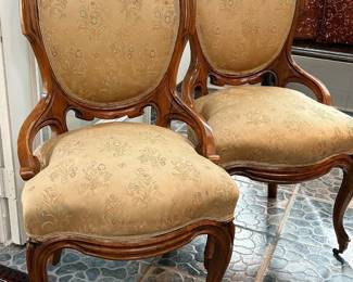 Pair of Victorian walnut parlor chairs with oval backs, late 19th to early 20th century.