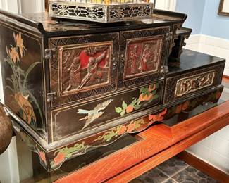 Vintage Chinese black lacquered table cabinet decorated with figures, birds and flowers.