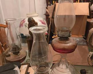 Assortment of lamps, oil lamps old and modern, chandeliers others stand up lamps. lamp shades different sizes