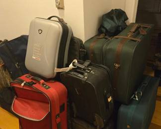 An assortment of luggage some roll on wheels for easy movement