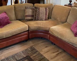 Curved sectional featuring soft beige upholstered cushions