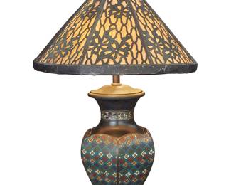 120 A champlevé and pierced metal table lamp Attributed to Lillian Palmer (1871-1961), early 20th century The enameled metal base issuing two lights, with a pierced metal and paper shade, electrified Height overall 26 in., diameter 17 1/8 in.; diameter of base 8 3/8 in. Estimate: $800 - $1,200