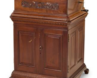 265 A Criterion music box Circa 1900 With single comb, playing 20 1/2 in. discs (43 included with the lot), housed in a carved mahogany case with a matching cabinet stand storing discs Affixed label reads: Restored by Heavenly Music, Music Box Restoration, 696 Ramona Avenue, Sierra Madre, CA 91024 Height of box 11 3/4 in., width 32 1/4 in., depth 25 1/2 in.; height of cabinet 31 1/2 in., width 30 1/2 in., depth 28 in. Estimate: $1,000 - $1,500