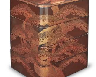 206 A Japanese lacquered wood jubako Taisho period (1912-1924) or later The four-tiered food box decorated in gold and brown lacquer with continuous landscape motifs of pine trees and rocky outcroppings, each square tier red-lacquered interior Height 11 7/8 in., width 8 3/4 in., depth 8 1/4 in. Estimate: $800 - $1,200