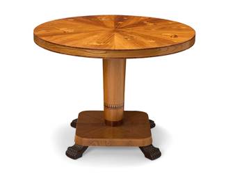 262 An Art Deco style marquetry zodiac table Probably Swedish, 20th century The top depicting celestial symbols and figures from the zodiac, raised on a pedestal support with paw feet Height 26 3/4 in., diameter 35 1/2 in. Estimate: $600 - $800