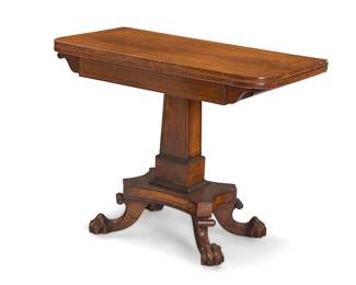 321 A William IV rosewood games table Circa 1835 The top folding open on a swivel revealing a green felt liner, raised on a pedestal base with paw feet Height 29 in., width 36 1/4 in., depth 18 1/8 in.; open height 27 1/2 in., width 36 1/4 in., depth 36 in. Estimate: $600 - $800
