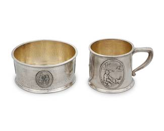 16 A Gorham sterling silver nursery mug and bowl Early 20th century With hammered surface, the mug with three applied ovals and the bowl with four ovals depicting nursery rhymes Each engraved: Philip 1909; each marked for Gorham and sterling; numbered 'A7525' or 'A7523' 2 pieces Height of cup 2 1/4 in., width 4 1/4 in., depth 3 1/4 in. Total weight 9.3 oz. troy approximately Estimate: $500 - $800