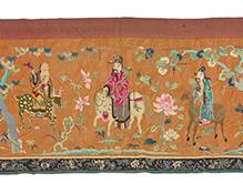 58 A large Chinese embroidered hanging of the 'Ba Xian' Eight Immortals 19th century or later The extra-wide textile worked on orange silk with polychrome silk and gilt wrapped threads featuring the Eight Immortals or 'Ba Xian' as well as three attendants, each figure astride a mythical creature, and each with various attributes and other auspicious and ceremonial items, the figures alternating with branching trees, twining floral elements, and architectural railings within a landscape, and with an embroidered floral border to three sides and fully lined in russet orange cotton Lining stamped in ink with possible signature 4 ft. 4 1/4 in. x 16 ft. 6 3/4 in. Estimate: $1,000 - $2,000