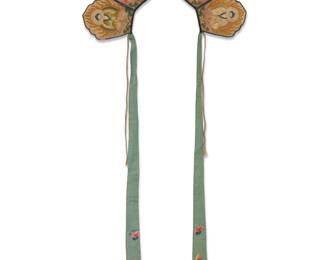 53 A Chinese Buddhist embroidered silk crown headpiece 19th century or earlier The crown with five silk panels each with polychrome silk embroidery featuring a seated figure, each with green silk lining verso, and with two long embroidered silk ties to each end, and two cording laces for attachment Overall 10 x 16 in.; Each panel 5 x 4 1/4 in.; Inner curve length 11 in.; Silk ties length 27 5/8 in. Estimate: $1,000 - $1,500