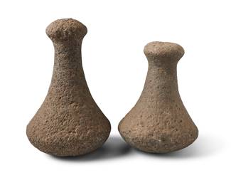 188 Two Hawaiian stone knobbed pounders Hawaiian Islands 2 pieces Height of larger 8 1/2 in., diameter 5 1/4 in.; height of smaller 6 3/4 in., width 5 in., depth 4 5/8 in. Estimate: $1,500 - $2,000