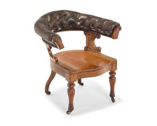 330 A Victorian tufted leather and carved wood captain's chair Mid-19th century The U-form tufted leather upholstered back raised on foliate carved supports over a conforming seat on turned baluster legs on casters Height 34 1/2 in., width 32 1/2 in., depth 30 1/4 in. Estimate: $300 - $500