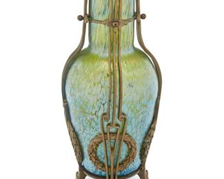 247 A Mueller Freres cameo glass landscape boudoir lamp Early 20th century The single-socket lamp with metal base, the standard and shade depicting a shoreline scene with trees and reeds, electrified Marked in the cameo: MULLER FRES Height 15 3/4 in., diameter 7 7/8 in. Estimate: $1,000 - $2,000