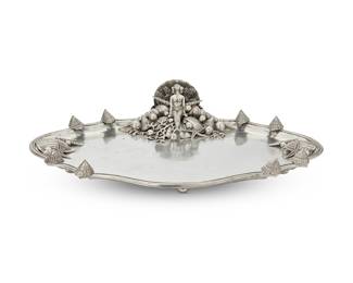 386 A Piero Figura for Atena pewter marine theme tray Late 20th century; Milan The shaped oval rim applied with cast shells at intervals, one side with a mermaid seated on a throne of shells, pearls, coral, and starfish, raised on six shell feet Impressed to underside: Figura Piero / Per Atena / [sun cipher] / ETAIN 95% Height 4 5/8 in., width 21 1/2 in., depth 15 1/2 in. Estimate: $300 - $500
