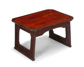 202 A Korean lacquered elmwood 'soban' low table Late Joseon dynasty (1392-1910) The tabletop with molded edges, raised on straight legs joined by an apron Height 11 in., width 18 in., depth 13 1/4 in. Estimate: $1,200 - $1,800