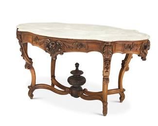 284 An American Rococo carved walnut and marble center table 18th century With intricate foliate designs and rocaille, the legs joined by curvilinear stretchers centered by an urn-form finial Height 31 in., width 60 in., depth 38 3/4 in. Estimate: $500 - $700