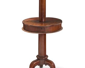 327 A Victorian mahogany dumbwaiter 19th century With two tiers, the middle with two hinged lids revealing an open compartment, raised on a tripod pedestal base Height 43 3/4 in., diameter 19 1/4 in. Estimate: $400 - $600