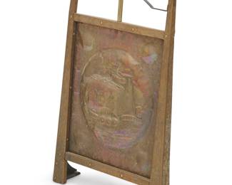 253 An Arts & Crafts copper fire screen Circa 1900, in the style of John Pearson (fl. 1885-1910) Depicting ships at sea, the supports crested by enamel accents Height 33 in., width 21 in., depth 6 1/2 in. Estimate: $300 - $500