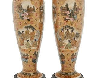 215 A pair of Japanese Satsuma ceramic vases Late Meiji era (1868-1912) or later Decorated with gilt filigree and figural tableaus, each raised on a carved wood stand and set in a custom formed case Each painted with Satsuma mark to underside 2 pieces Height of each 7 3/8 in., diameter 2 1/2 in.; height of case 3 5/8 in., width 9 5/8 in., depth 8 1/8 in. Estimate: $700 - $900