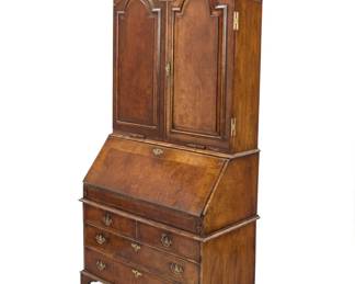 314 A Queen Anne style walnut secretary First half 20th century The upper cabinet doors opening to reveal profuse drawers and document cubbies, above a locking drop front revealing an inset leather writing surface and more storage drawers, on a chest of three large long drawers, raised on bracket feet Height of upper cabinet 52 in., width 43 in., depth 13 1/2 in.; height of lower 42 1/2 in., width 22 1/2 in., depth 22 in. Estimate: $800 - $1,200