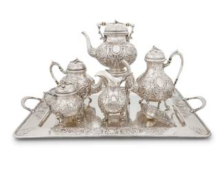36 A German Renaissance Revival .800 silver tea & coffee service Georg Roth & Co, Hanau, circa 1900 Each with repoussé and chased decoration Comprising: Hot water kettle on stand (height without handle 12 3/4 in., width 8 5/8 in., diameter 6 3/4 in.) Coffee pot (height 9 1/4 in., width 9 7/8 in., diameter 5 3/4 in.) Teapot (height 7 1/2 in., width 10 1/8 in., diameter 5 5/8 in.) Covered sugar bowl (height 5 7/8 in., width 6 in., diameter 4 1/4 in.) Creamer (height 6 1/2 in., width 5 1/4 in., diameter 4 1/4 in.) Tea strainer (length 5 7/8 in.) Handled tray (width 27 1/8 in., depth 18 5/8 in.) Each with pseudo hallmarks crowned 'A', crowned 'P', and crowned 'GR' 8 pieces Total weight 223.4 gross oz. troy approximately Estimate: $1,000 - $2,000
