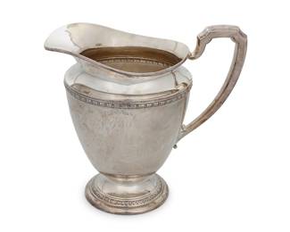 19 An International sterling silver pitcher 20th century Marked: INTERNATIONAL STERLING E26-1 5 PINTS Height 9 1/2 in., width 10 in., depth 7 in. 25 oz. troy approximately Estimate: $800 - $1,200