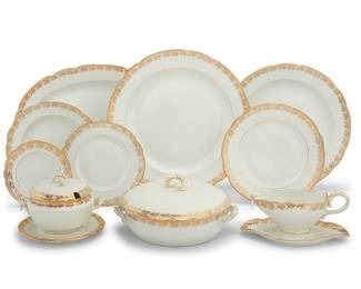 349 An extensive Kornilov Brothers porcelain dinner service Late 19th/early 20th century Comprising: 40 dinner plates (9 5/8 in.) 17 salad plates (8 1/8 in.) 19 bread & butter plates (6 3/8 in.) 22 soup plates (9 1/2 in.) 2 oval serving platters (19 x 13 1/8 in.) 1 smaller oval serving platter (17 1/2 x 12 1/8 in.) 1 oval fish platter (23 x 11 3/4 in.) 4 round chargers (larger pair 14 1/8 in.; smaller pair 12 7/8 in.) 2 small diamond bowls (10 5/8 x 5 3/4 in.) 1 sauce boat with attached underplate (height 4 1/4 in., width 9 in., depth 5 1/2 in.) 2 covered sauce tureens on stands (height 5 1/4 in., diameter 7 1/4 in.) 2 entree dishes, one with cover (width 10 5/8 in., depth 8 7/8 in.) 1 circular serving bowl (8 5/8 in.) Each with factory shield mark decal 114 pieces Estimate: $1,000 - $2,000
