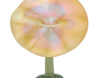 238 A Tiffany style pulled feather glass jack in the pulpit vase Early 20th century With applied partial Tiffany Furnaces paper label Height 7 1/8 in., width 5 5/8 in., depth 3 in. Estimate: $500 - $800