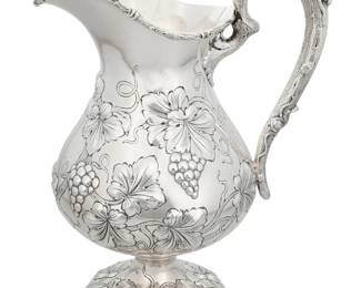 12 An American repoussé sterling silver pitcher 20th century With grape vines in relief Marked: STERLING 2747 Height 12 1/2 in. 39.6 oz. troy approximately Estimate: $500 - $700
