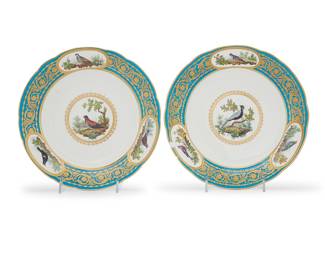 170 A pair of Sèvres porcelain plates from the Deltuf des Rozières service Circa 1787 The centers painted with a single bird, within scrolling foliate gilt heightened bleu celeste borders interspersed by three vignettes with birds, all named to the undersides Blue interlaced Ls mark above painter's mark DT and letter date code KK to the right, gilder's mark HP and 2000 in gilt 2 pieces Diameter of each 9 1/2 in. Estimate: $800 - $1,200