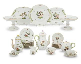 6 A Herend porcelain 'Rothschild Bird' tea and dessert service 20th century Comprising: 1 coffee pot, 1611 (10 1/4 in.) 2 teapots, 1612 and 1603 (5 1/2 in. and 8 1/2 in.) 2 cream jugs, 1843 (3 3/4 in.) 1 open sugar, 685 (height 2 3/4 in., diameter 5 in.) 2 compotes, 311 (height 9 in., diameter 6 1/2 in.) 3 serving platters with branch handles, 430, 411, 1173 (oval 13 in., circular 12 1/2 in., square 11 1/4 in.) 12 plates, 1518 (7 1/2 in.) 9 plates, 1515 (6 in.) 9 teacups and 8 saucers, 734 18 demitasse cups and 17 saucers, 1728 1 two-division server, 7511 (height 5 1/2 in., diameter 18 1/2 in.) Various blue printed factory marks above shape numbers and pattern code RO, some impressed 'HEREND' and with shape numbers 85 pieces Estimate: $1,500 - $2,000