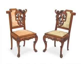 225 A pair of French chinoiserie carved wood side chairs Late 19th century, in the manner of Cyrille Ruffier des Aimes (1844-1916) Each seatback carved with ornate dragon and cloud openwork and jacquard upholstery with brass tacking, the apron with meandering openwork above front legs carved with archaistic motifs ending in paw feet 2 pieces Height of each 36 3/4 in., width 19 1/2 in., depth 20 1/2 in. Estimate: $2,000 - $4,000