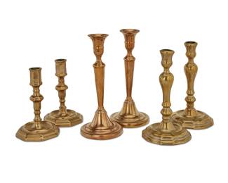 152 Three pairs of French brass candlesticks 18th/19th century Comprising a pair of Louis XV candlesticks with baluster standards and urn-form nozzles, a pair with conical standards and flared urn-form nozzles with round plinths, and a pair with barrel-form nozzles and octagonal plinths 6 pieces Height of tallest 8 3/4 in., diameter 3 7/8 in.; height of shortest 6 in, width 3 7/8 in., depth 3 7/8 in. Estimate: $400 - $600