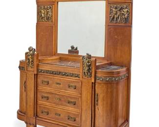 260 An Italian Art Deco gilt bronze mounted dresser Circa 1925 With central mirror flanked by upper single-light lamps with beaded fringes above gilt-bronze panels depicting putti and marquetry floral elements, the dresser chest with marble top, two watch/trinket compartments with glazed hinged top, and opposed locking cabinets centering three locking drawers, electrified Height of lower 48 1/2 in., width 61 1/2 in., depth 25 1/2 in. Estimate: $1,500 - $2,500