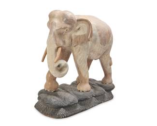 397 A carved wood model of an elephant Late 20th century The figure whitewashed, on a painted wood base Height 54 1/2 in., width 55 1/2 in., depth 26 in. Estimate: $600 - $800