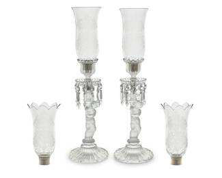 146 A pair of Baccarat glass 'Enfant Lusters' candlesticks and four shades Mid-20th century Comprising a pair of bases with cut glass drop elements and two pairs of shades, one pair with ribbed rim Each base and shade etched with factory mark 6 pieces Height of each base 15 in., diameter 6 1/4 in.; height of shades 9 1/8 in., diameter 4 7/8 in. Estimate: $800 - $1,200