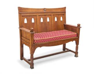 393 A Provincial oak hall bench Early 20th century The shaped crest rail with central openwork S-form motif above a later upholstered seat cushion flanked by flat armrests with ball finials at the terminals Height 43 1/2 in., width 50 in., depth 22 3/4 in. Estimate: $400 - $600