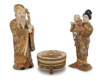 217 Two Japanese Satsuma moriage ceramic figures and circular box Early 20th century Comprising a sage with a staff, a lady holding a child, and a tripod footed box with warriors depicted on the lid Each bearing red painted mark for Kusube Sennosuke (1859-1941) 3 pieces Height of taller figure 12 1/4 in., width 4 5/8 in., depth 5 in.; height of box 3 1/4 in., diameter 5 5/8 in. Estimate: $600 - $900