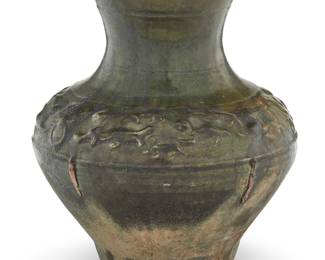 108 A Chinese green glazed molded pottery Hu form jar Han Dynasty (206 BCE-220 CE) With beasts and masks in bas relief along the shoulder Height 9 1/4 in., diameter 7 7/8 in. Estimate: $500 - $700