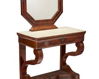 166 A Charles X mahogany dressing table Second quarter 19th century With swing frame octagonal mirror above a white marble top and single locking drawer, opening to reveal a brass inkwell and sliding top compartment with inset gilt-stamped green leather surface, raised on paw feet, the drawer front and stretcher with book matched veneer Height of table 29 1/4 in., width 32 1/4 in., depth 16 1/2 in.; height of mirror 23 3/4 in., width 29 1/4 in., depth 2 3/4 in. Estimate: $500 - $700