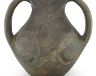 107 A Chinese Sichuan burnished black pottery amphora Han dynasty (202 BCE-220 CE) Carved with taotie eyes Height 6 7/8 in., width 7 1/4 in., depth 5 3/4 in. Estimate: $700 - $900