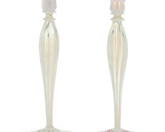 237 A near pair of Tiffany pastel glass candlesticks Early 20th century One with applied factory gold-on-green paper label 2 pieces Height of each 13 1/2 in., diameter 5 5/8 in. Estimate: $700 - $900